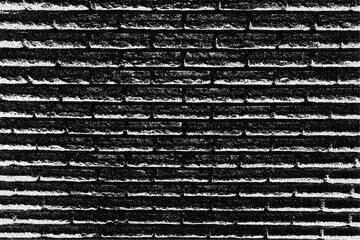 Close up view of a rough textured, dark gray brick wall showing its horizontal stacking with visible mortar lines. © Graphicagfx_overlays