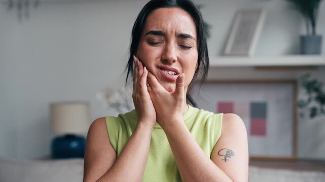 Video of beautiful woman in pain with a toothache at home