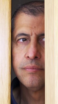 Man spying and entering through the door as concept of nosy man