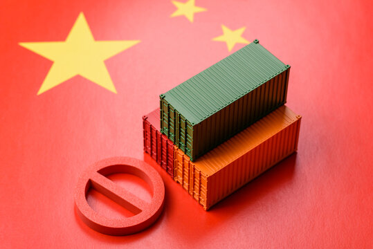 The cargo container ban on the China flag as a conceptual backdrop. The cargo container embargo