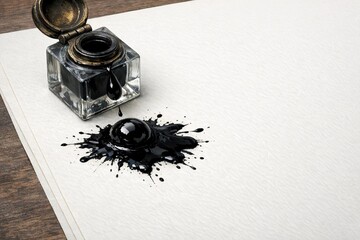 Naklejka premium A black ink bottle sitting on a piece of paper, great for adding a touch of elegance to any design