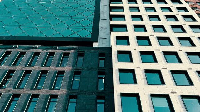 Modern Mixed-Use Building Facade Bottom-Up Wide Angle View | Apartments Hotel and Office Zones with Tinted Square Windows White Stone and Geometric Glass Panels | Urban Architecture Walk-By Shot
