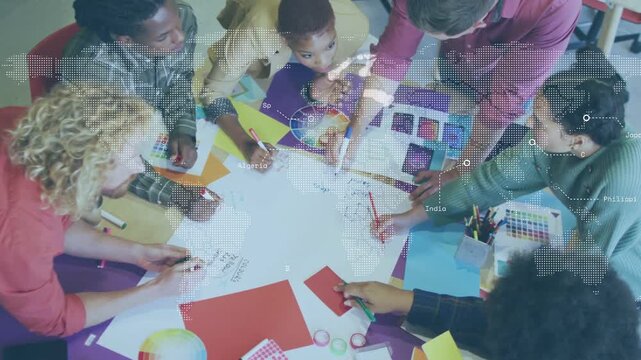 Designers sorting swatches, sketching branding on sheet as map overlay moving over materials