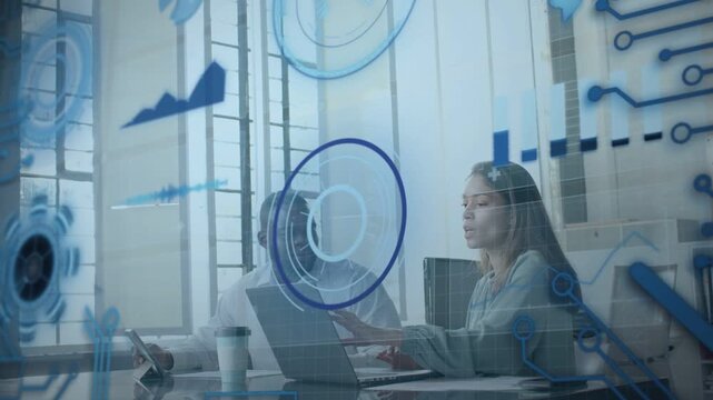 Woman typing and man tapping device initiating HUD graphs circling desk, working business data