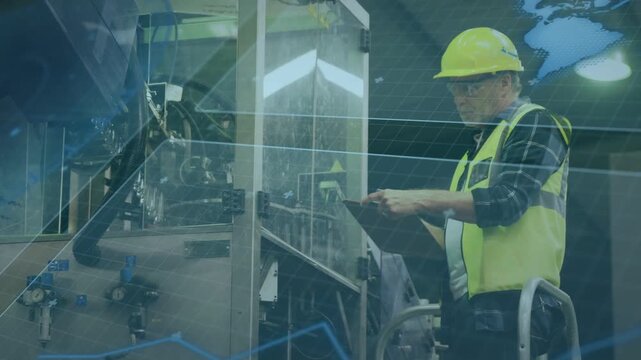 Senior worker standing on step tapping tablet, initiating factory inspection, checking clear panel
