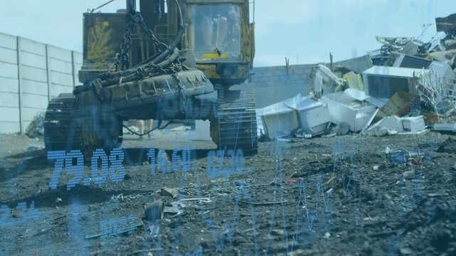 Large yellow excavator lowering electromagnet as operator pulling controls, lifting scrap metal