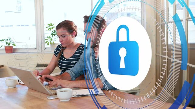 Team typing at laptop, data entry activating blue secure padlock overlaying pair rotating rings