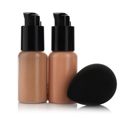 Obraz premium Bottles of skin foundation and makeup sponge isolated on white