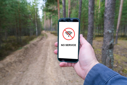 Smartphone showing no service signal on forest road, mobile connection lost in remote wilderness