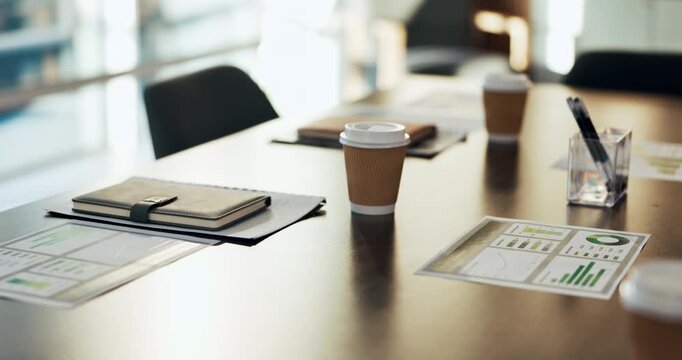 Empty, coffee and table with paperwork in boardroom for finance meeting with chart, graph or report. Corporate office, business and drinks with documents, notebook or workplace for financial workshop
