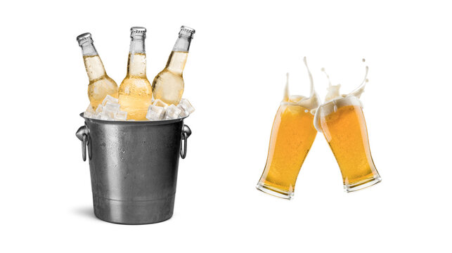 Group of light beer bottles chilling in an old metallic ice bucket alongside two clinking glasses of foamy golden beer splashing with white background, clinking
