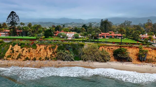 Footage along the gorgeous Butterfly Beach in Montecito area of Santa Barbara, California, USA. Luxurious mansions in the lush greenery on the picturesque cliffs.