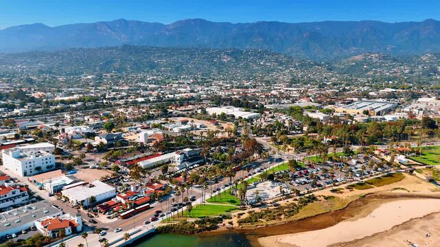 Approaching the lively road lined by the palm trees. Amazing scenery of Santa Barbara, California, USA on sunny day.