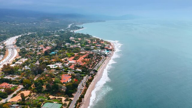 Stunning shore of the Pacific Ocean with picturesque green urban area. Beautiful Santa Barbara, California, USA from drone.