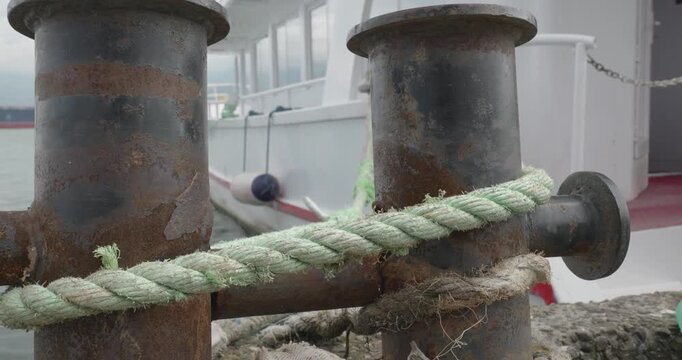 Rusty Marine Bollards with Nautical Rope at Harbor