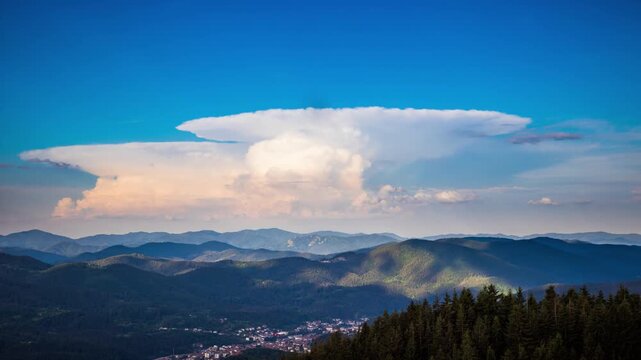 Dangerous clouds scatter across the sky from a explosion in the depths of the Rhodope Mountains with spruce forests, meadows and villages