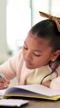 Learning, child or writing on paper in book for math homework, calculation solution or study. Student, kid or numeracy workbook at table for problem solving, division answer or homeschool assessment