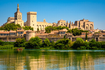 Panoramic view of the historic center, Papal Palace and ancient city walls rise above the Rhone River on a sunny summer day, Avignon, Provence, France © Olena Zn