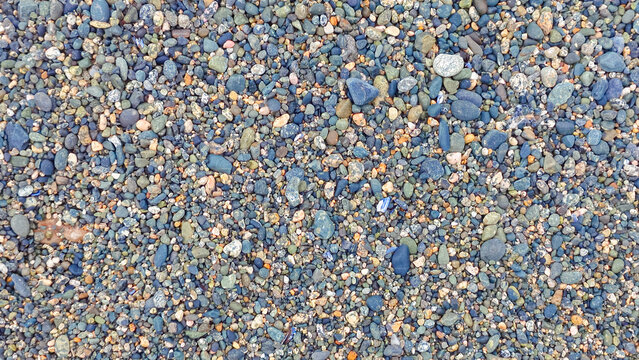 Close up of small beach pebbles texture