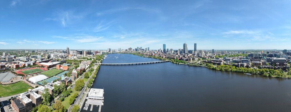 Panoramic aerial drone view of Boston Back Bay skyline, Prudential Tower, and Charles River Esplanade on a clear summer day, featuring historic brownstones and city skyscrapers, USA.