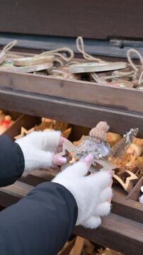 Close Up Hands Choosing Christmas Decoration at Holiday Market Stall