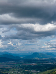 Fototapeta premium Overcast Mountain Landscape With Dramatic Clouds Over Chilliwack Valley, British Columbia, Canada