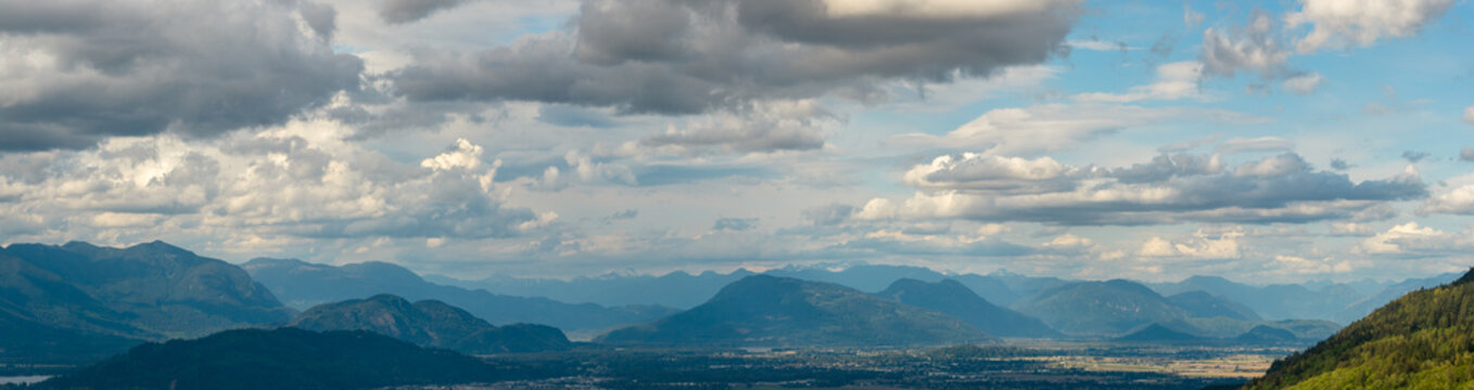 Dramatic Mountain Range and Valley Under Cloudy Sky Near Chilliwack, British Columbia, Canada