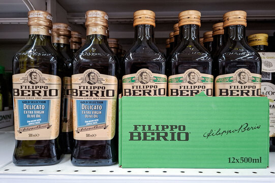 MOSCOW, Russia - March 21, 2026.Bottles of Filippo Berio Delicato extra virgin olive oil in a green shipping box on a store shelf in Russia
