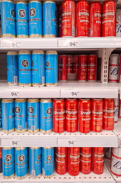 MOSCOW, Russia - March 21, 2026.Lowenbrau and Krusovice beer cans on display with price tags at a supermarket shelf in Russia