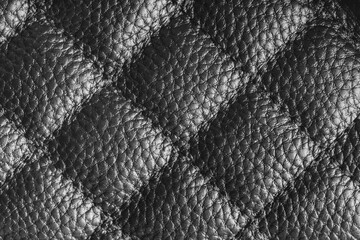 Obraz premium Close up, macro of gray quilted leather texture with stitched diamond pattern, luxury material surface shining metal effect for fashion, upholstery or design wallpaper, rough, relief background