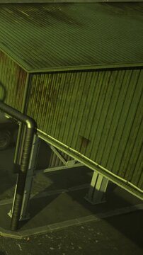 A green building stands at an angle, supported by metal beams. The scene shows a construction site with an unfinished look and nearby materials scattered around.