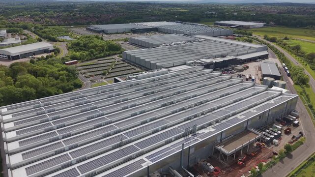 Aerial View Of Warehouses Covered In Solar Energy Panels