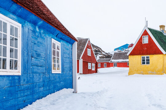 Traditional colorful wooden houses in the old historic district of Sisimiut during snowfall with arctic winter scenery, Sisimiut, Qeqqata, Greenland