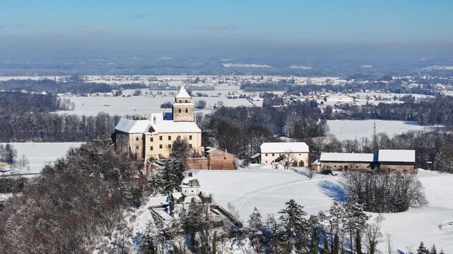 Aerial view of Schloss Ehrenhausen and the Eggenberg Mausoleum in the snowy landscape of Sudsteiermark in Ehrenhausen, Styria, Austria.