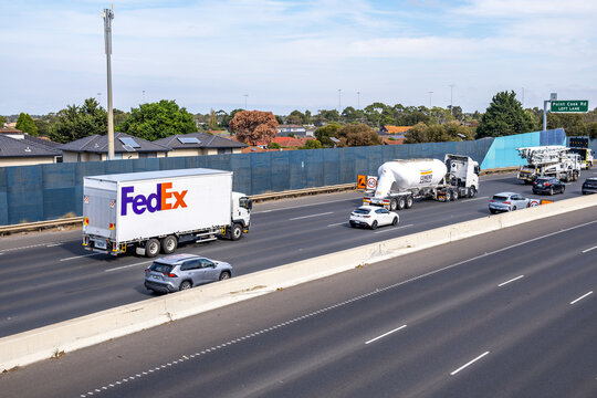 A FedEx delivery truck travels along a busy freeway in Melbourne, Australia. It's an American multinational  company specializing in transportation, e-commerceand business services