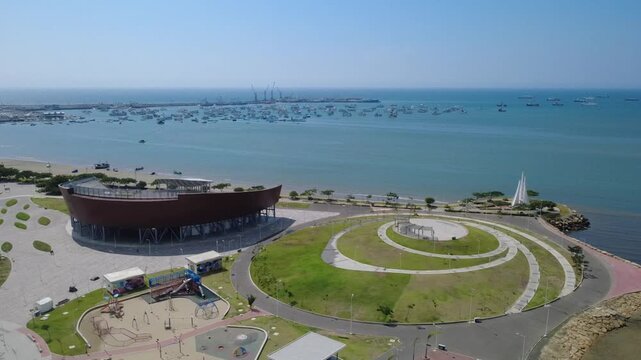 Aerial view from Megaparque breakwater to acoustic shell with Manta port background, Ecuador.