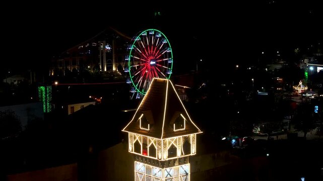 Capivari Village In Campos Do Jordao Sao Paulo Brazil. Bird Eye View Of Stunning Ferris Wheel In A Amusement Park. Night Street Downtown Cityscape.