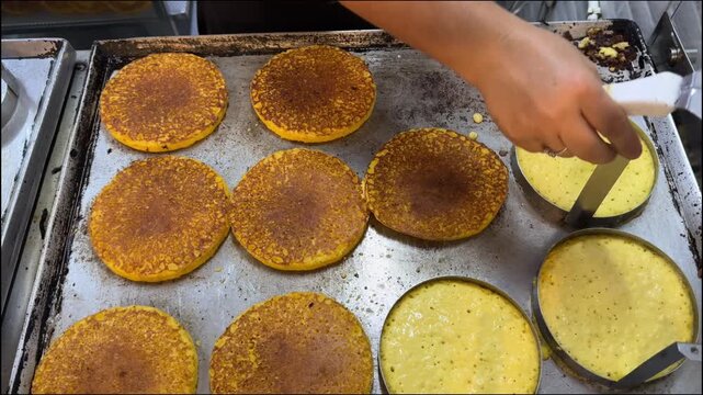 Chef cooking colombian arepas on a griddle