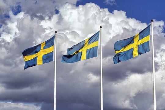 Three Swedish flags, national flags side by side, dramatic clouds, Bergs slussar, mountain, Link&ouml;ping, &Ouml;sterg&ouml;tland, Sweden