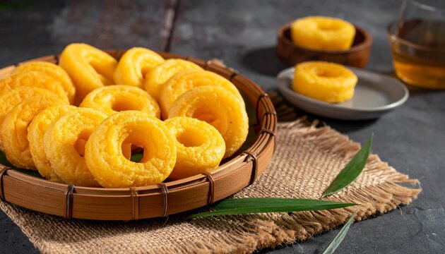 Traditional Malaysian Kuih Keria Sweet Potato Donuts on Woven Bamboo Tray