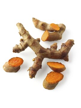 Fresh turmeric  or tumeric root (Curcuma longa) against a white background