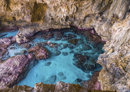 Tourists snorkeling in the Avaiki rock tide pools, South Pacific, Niue