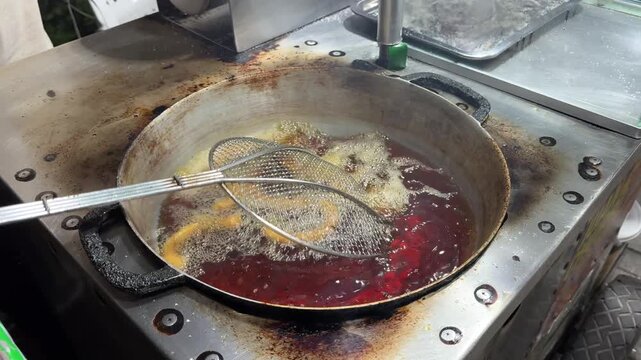 Deep frying delicious churros in hot oil