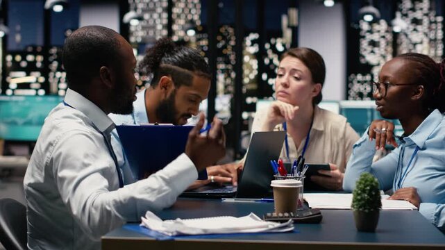 Company manager leading diverse team, fostering positive office culture of operational efficiency. Team leader in workspace supervising administrative staff, setting performance goals.