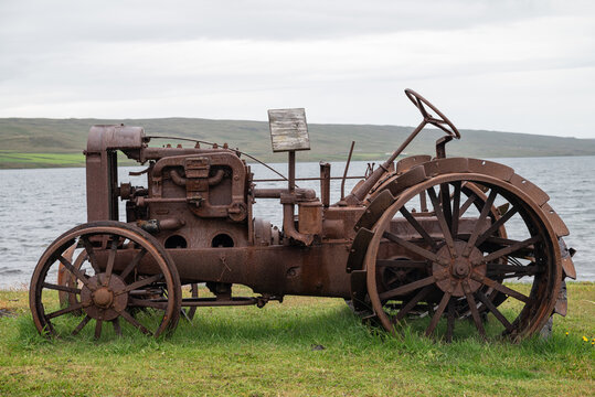 Old rusty tractor next to the coast