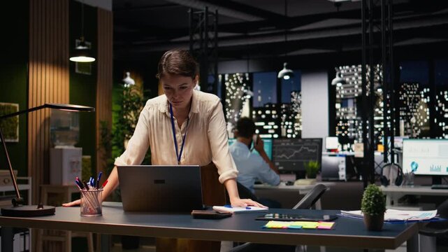 Completing spreadsheets on laptop, employee inputting and analyzing data. Woman researching information online and typing information to align with business intel and objectives.