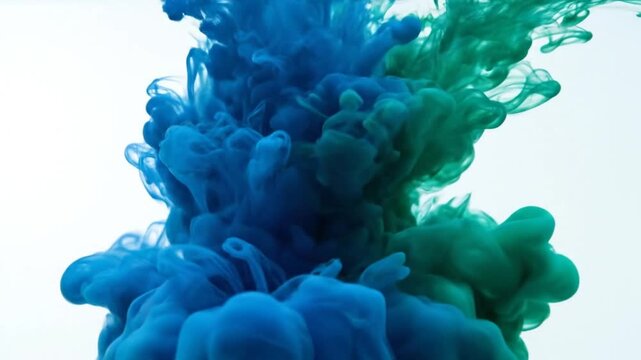 Mesmerizing slow motion blue and green ink clouds mixing in water, abstract art, vibrant colors