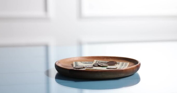 Tips on table and waiter working in cafe, selective focus