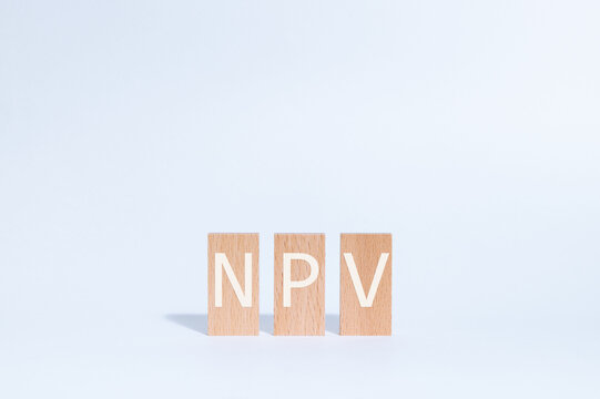 Eye-catching image of NPV text on wood blocks. The word stands for Net Present Value.
