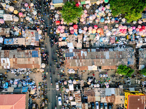 Aerial view of the bustling Panteka Market with colorful umbrellas, crowded streets, and rusty corrugated rooftops Kaduna, Kaduna, Nigeria.